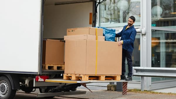 Pictre of a man unloading a truck with IKEA products