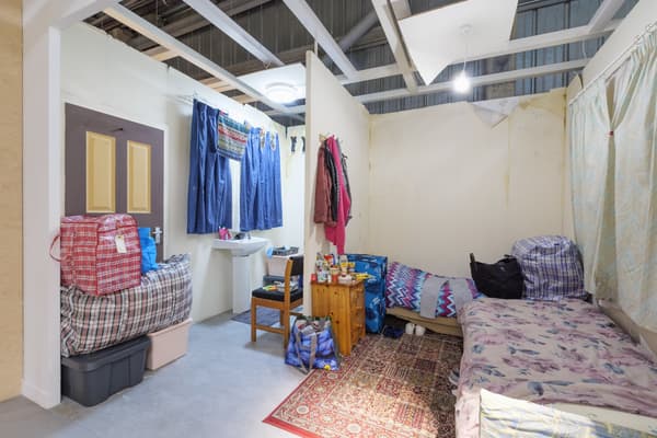 Picture of a real life roomset, showing two beds, a rug and a bathroom
