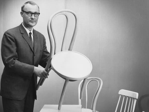 Picture of Ingvar Kamprad holding an IKEA chair