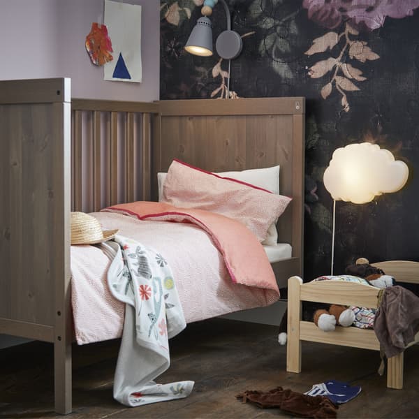 Picture of toddler’s bed with bedding and smaller bed for toys.