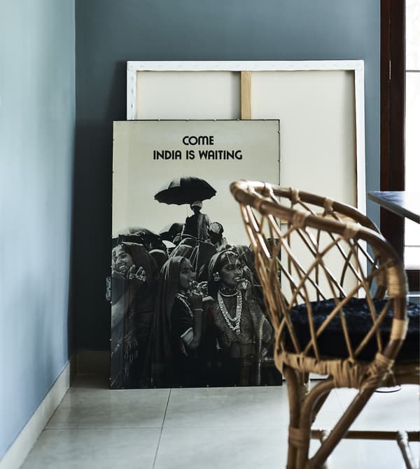Pictures leaning against a blue wall.