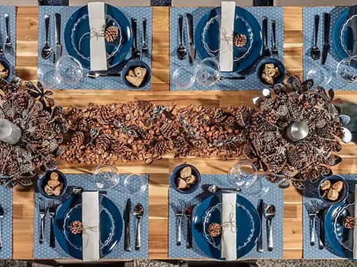 place mat with a wine glass, glass, cutlery, plate and dark turquoise bowl
