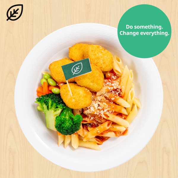 Plant-based pieces with organic penne pasta with tomato sauce, with plant food symbols at top left corner. A green sustainable tag is on the top right hand corner of the dish that reads 