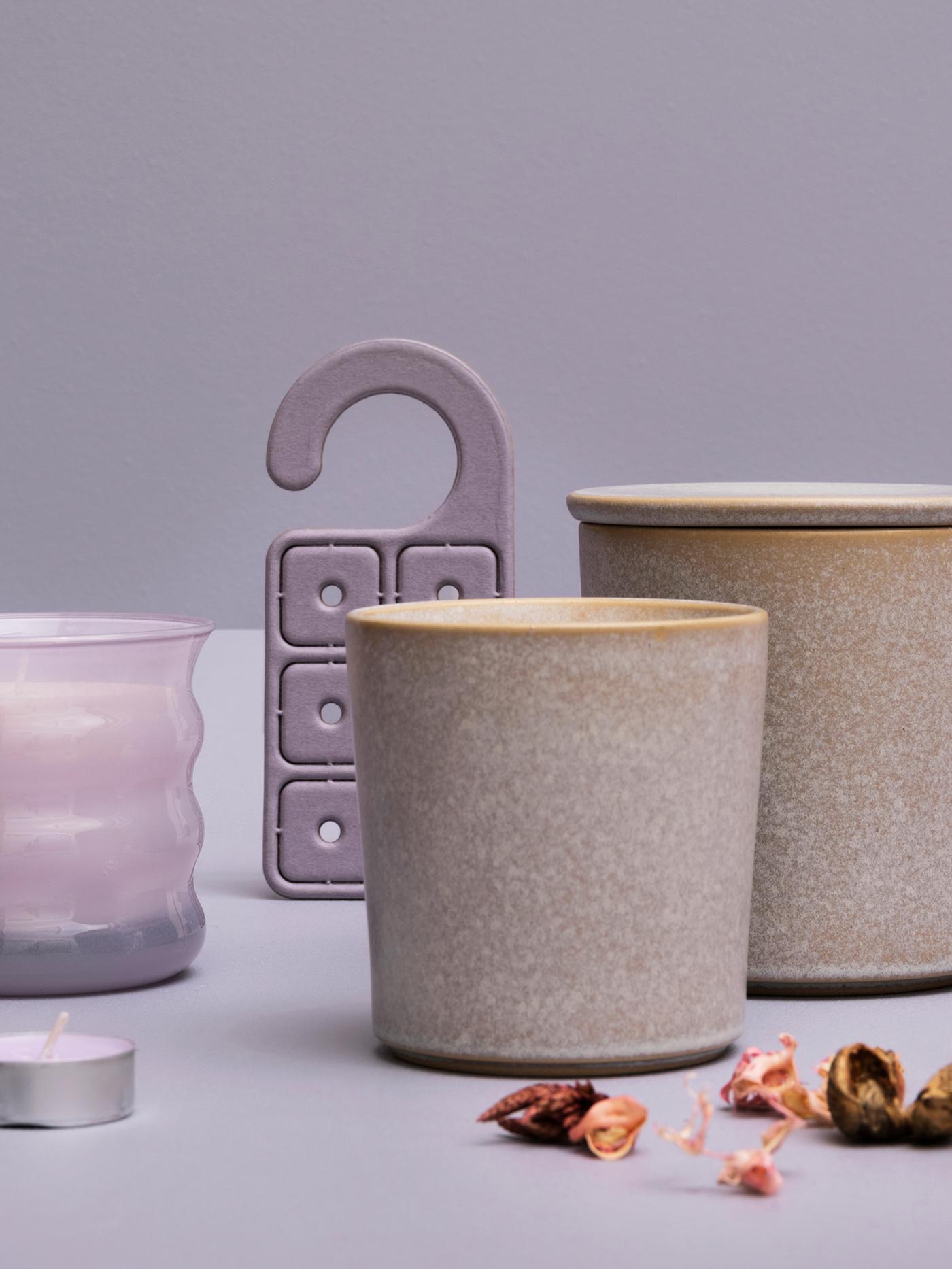 Plusieurs bougies JÄMNMOD parfum pois de senteur, un pot-pourri et un cintre parfumé devant un arrière-plan mauve.