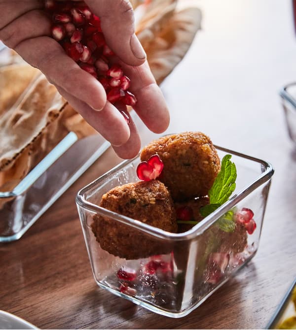 Pomegranate seeds are sprinkled over falafel.