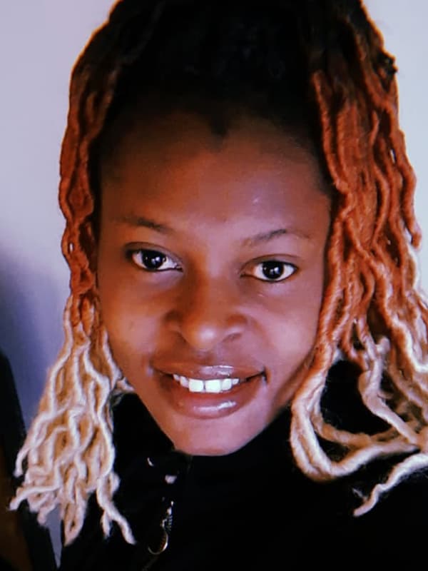 Portrait of Esperance, a Congolese refugee and IKEA Switzerland co-worker, smiling into the camera.