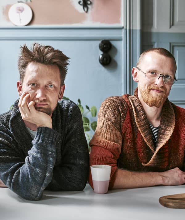 Portrait of Radek and Łukasz sitting together at a table.