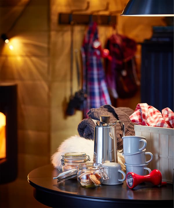 Prepare for some family time with warm drinks, blankets, and an IKEA LJUSA torch for telling scary stories.