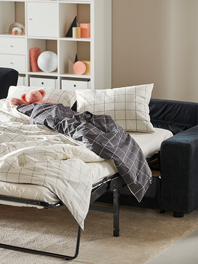 Pull out couch with bedding on it