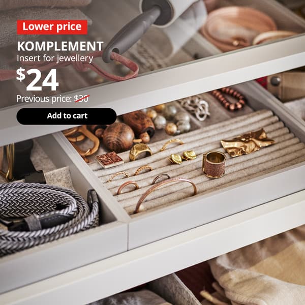 Pull out drawer of a PAX wardrobe extended to show a KOMPLEMETN insert for jewellery, organising various types of jewellery. 