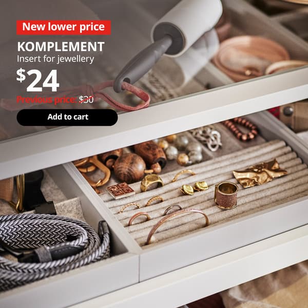 Pull out drawer of a PAX wardrobe extended to show a KOMPLEMETN insert for jewellery, organising various types of jewellery. 