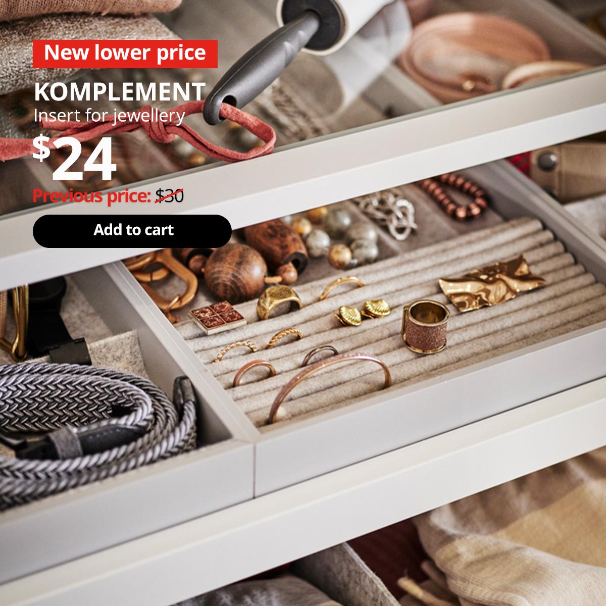 Pull out drawer of a PAX wardrobe extended to show a KOMPLEMETN insert for jewellery, organising various types of jewellery. 