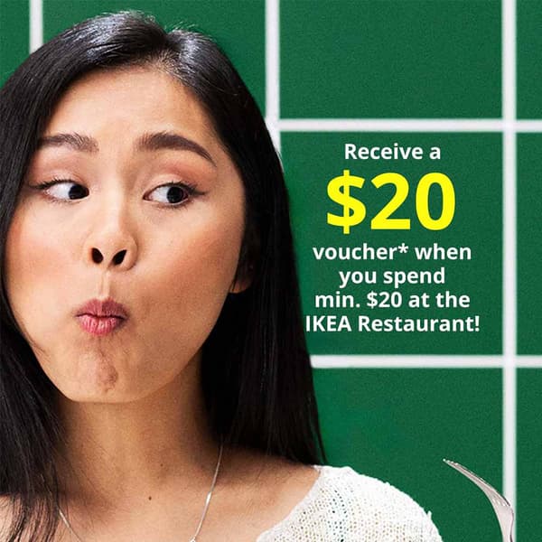Receive a $20 home furnishing voucher* when you spend min. $20 at the Swedish Restaurant. Woman chewing meatball and holding a fork.