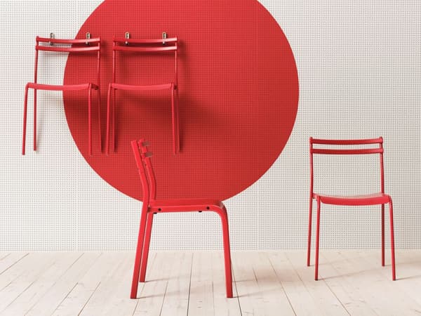 Red chairs on floor and hanging form peg board
