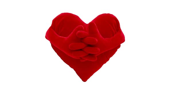 Red heart-shaped cushion with two hands clasped together in the center on a white background.