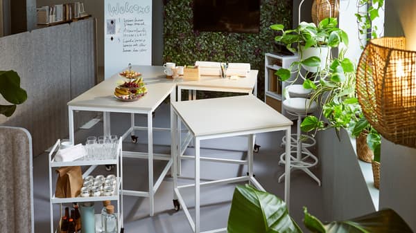 Refreshments served in a meeting space with TROTTEN tables and a NISSAFORS trolley, framed by a plant wall and EILIF screens.