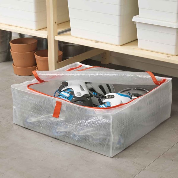 Rollerblades are stored inside a PÄRKLA storage box, which is placed under an IVAR cabinet