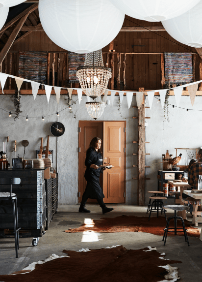 Rustic interior of restaurant with waitress carrying a tray out of focus
