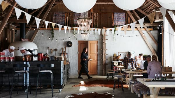 Rustic interior of restaurant with waitress carrying a tray out of focus