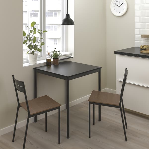 SANDSBERG dining series in small space dining room with two SANDSBERG chairs at a table. 