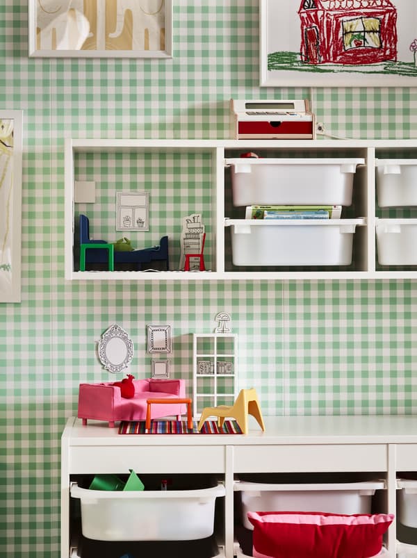 Section of a green-and-white chequered wall with TROFAST storage combinations, both fixed to the wall and on the floor.