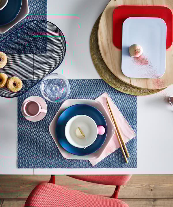 Section of dining table with an artful dessert setting for one, including coordinated colours, shapes and materials.