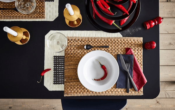 Section of dining table with an artful setting for one, including coordinated colours, shapes and materials.