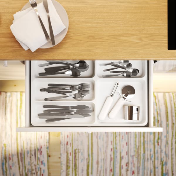 Seen from above is an open kitchen drawer with STÖDJA cutlery tray inside where cutlery and kitchen utensils are organised.