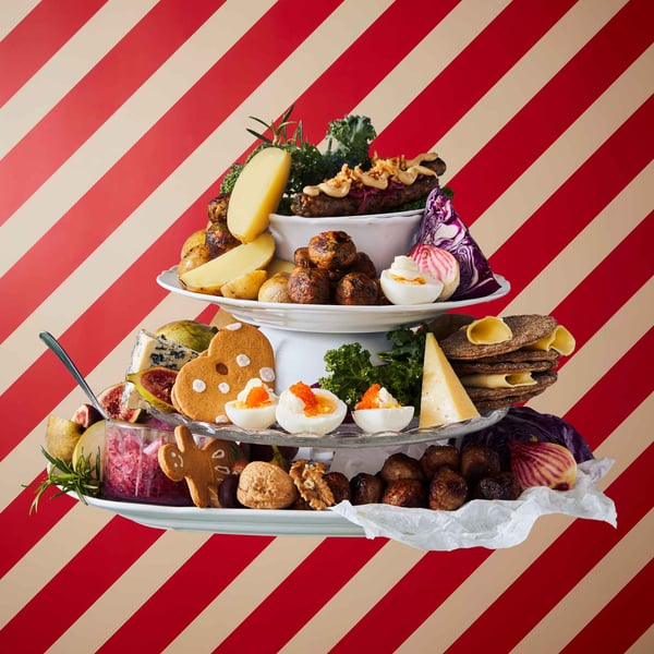 Serving dishes stacked on top of each other with a variety of food.