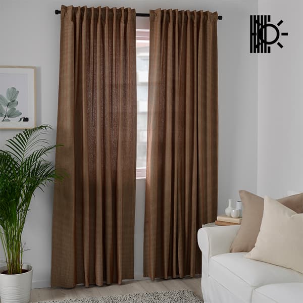 Set of brown room darkening curtains hanging over windows in living room in Singapore