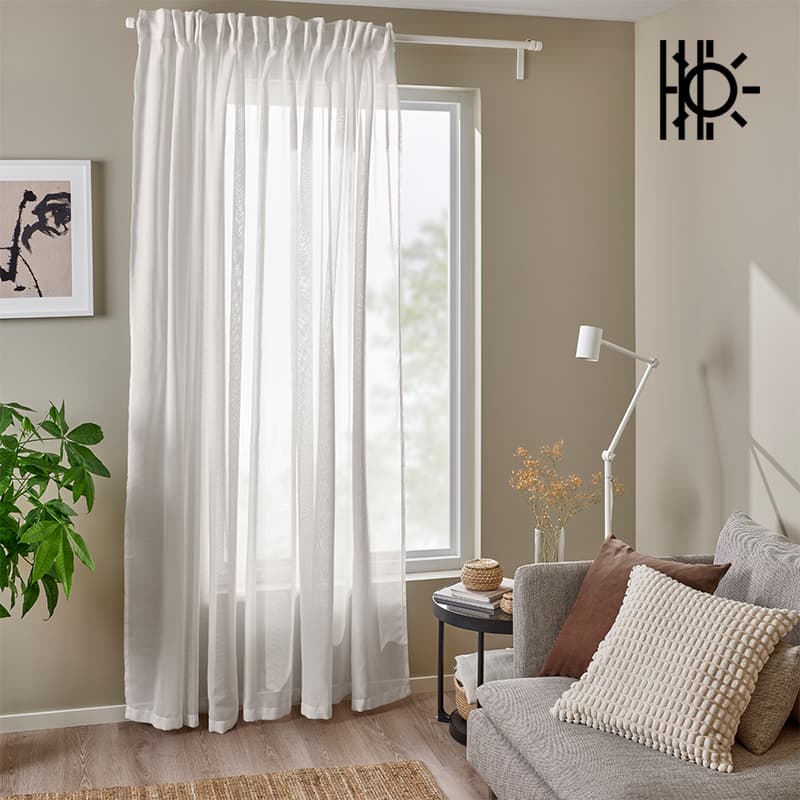 Set of white sheer fabric curtains hanging over windows in living room in Singapore
