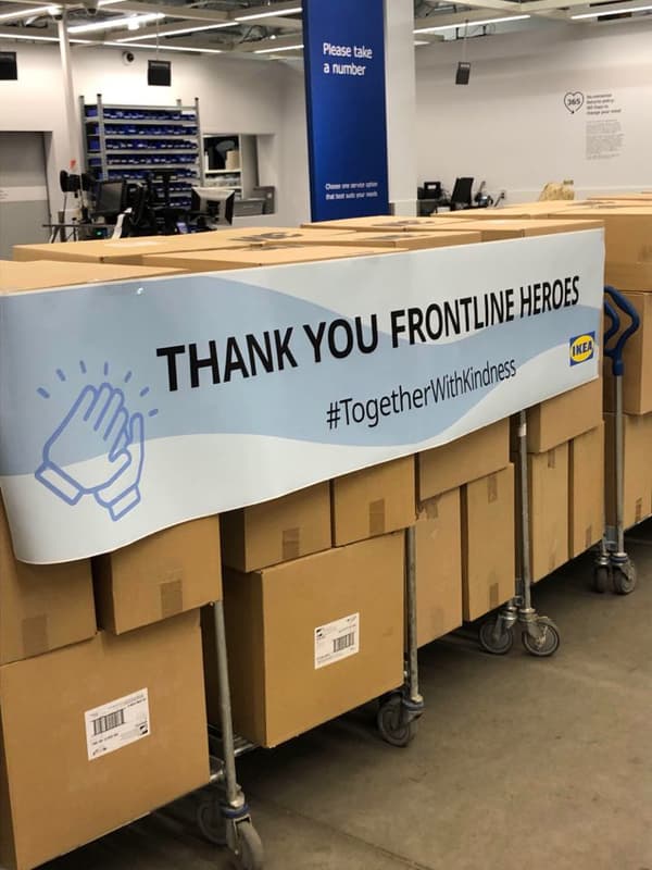 Several carts of cardboard boxes with a banner reading 'Thank you frontline heroes' across them.
