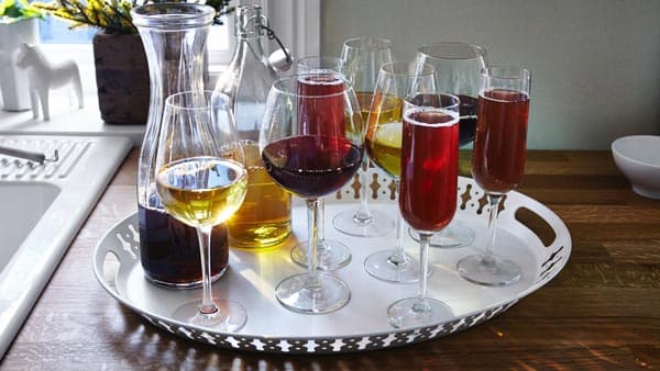 Several different sizes of wine glasses on a silver tray