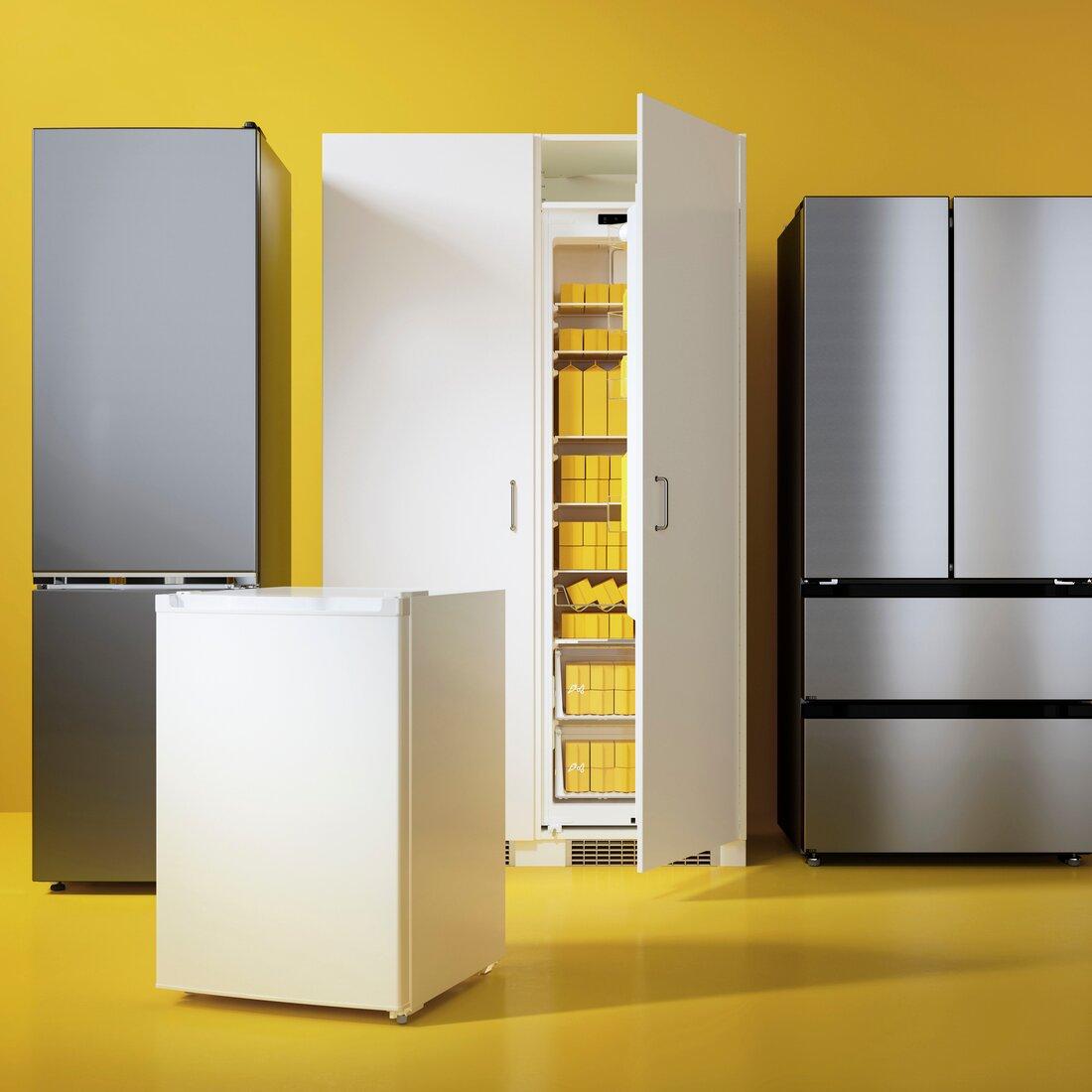 Several fridges and freezers of different sizes and models are placed against a bright yellow-orange background.