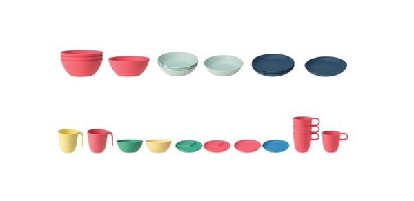 Several green, yellow, pink, and blue bowls, plates, and cups from the HEROISK series lined up against a white background.