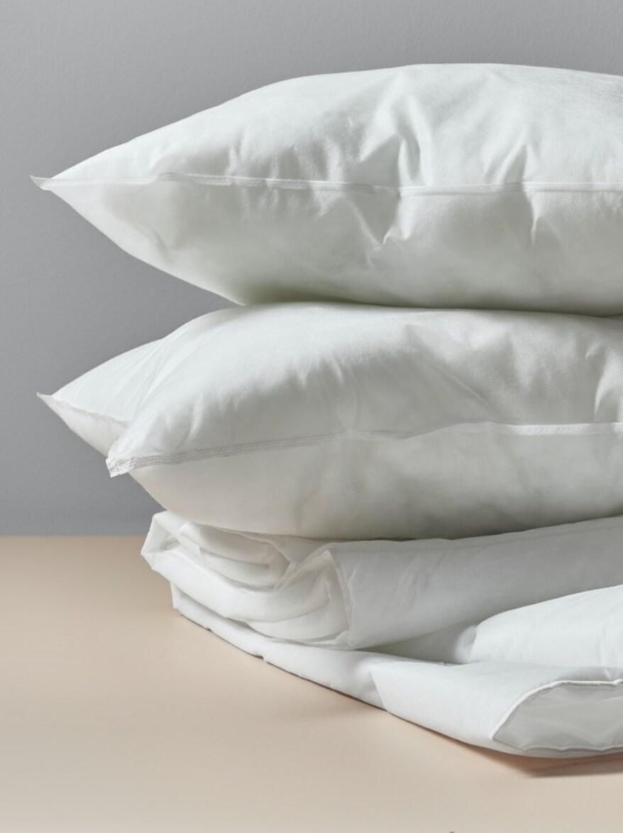 Several pillows piled on top of each other.
