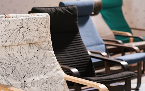 Several POÄNG armchairs sitting in a row- one with a 
