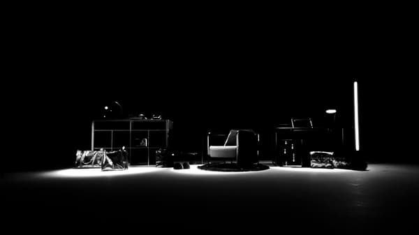 Several products from the OBEGRÄNSAD collection in a black room lit with white lighting.