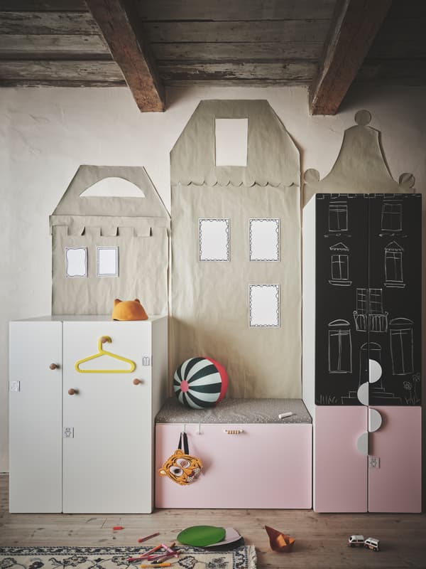 Several units of SMÅSTAD storage series with different coloured fronts and handles of various styles placed in a kid’s room.