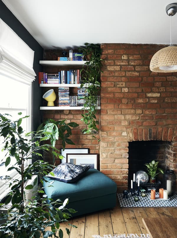 Shelves in an alcove and a green footstool.