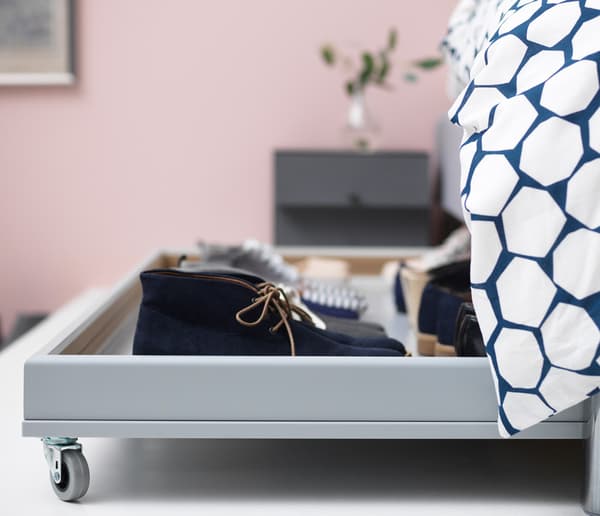 Shoe storage on castors under the bed