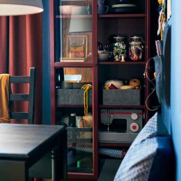 Show off your favorites and keep them dust-free too! Try the IKEA classic BILLY dark red bookcase with two glass-doors.
