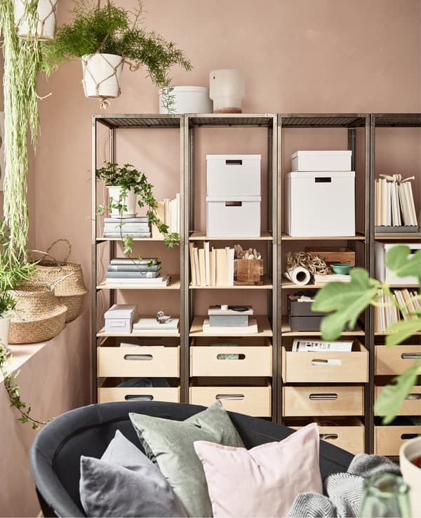Side-by-side VEBERÖD shelving units in steel and birch create storage and organisation in this pink living room.