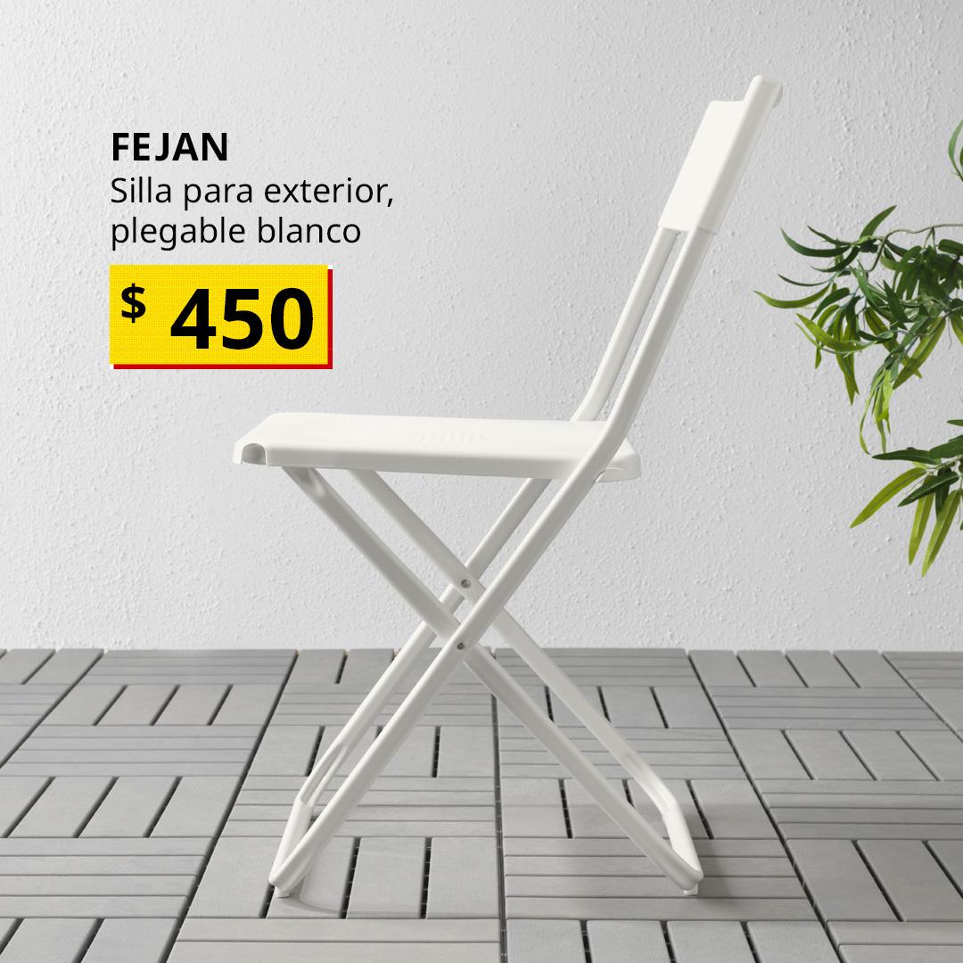 Silla plegable FEJAN en color blanco para exteriores, colocada en un espacio exterior.