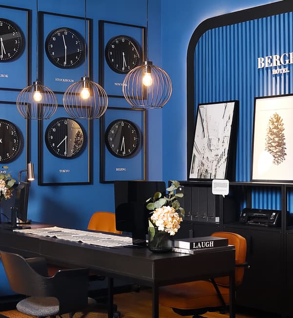 Six clocks hung on a dark blue wall.