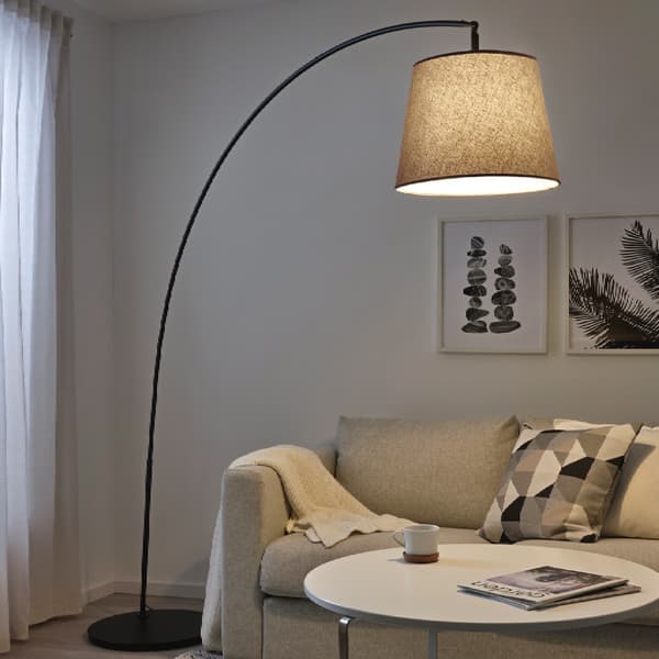 SKAFTET arched floor lamp with black base.