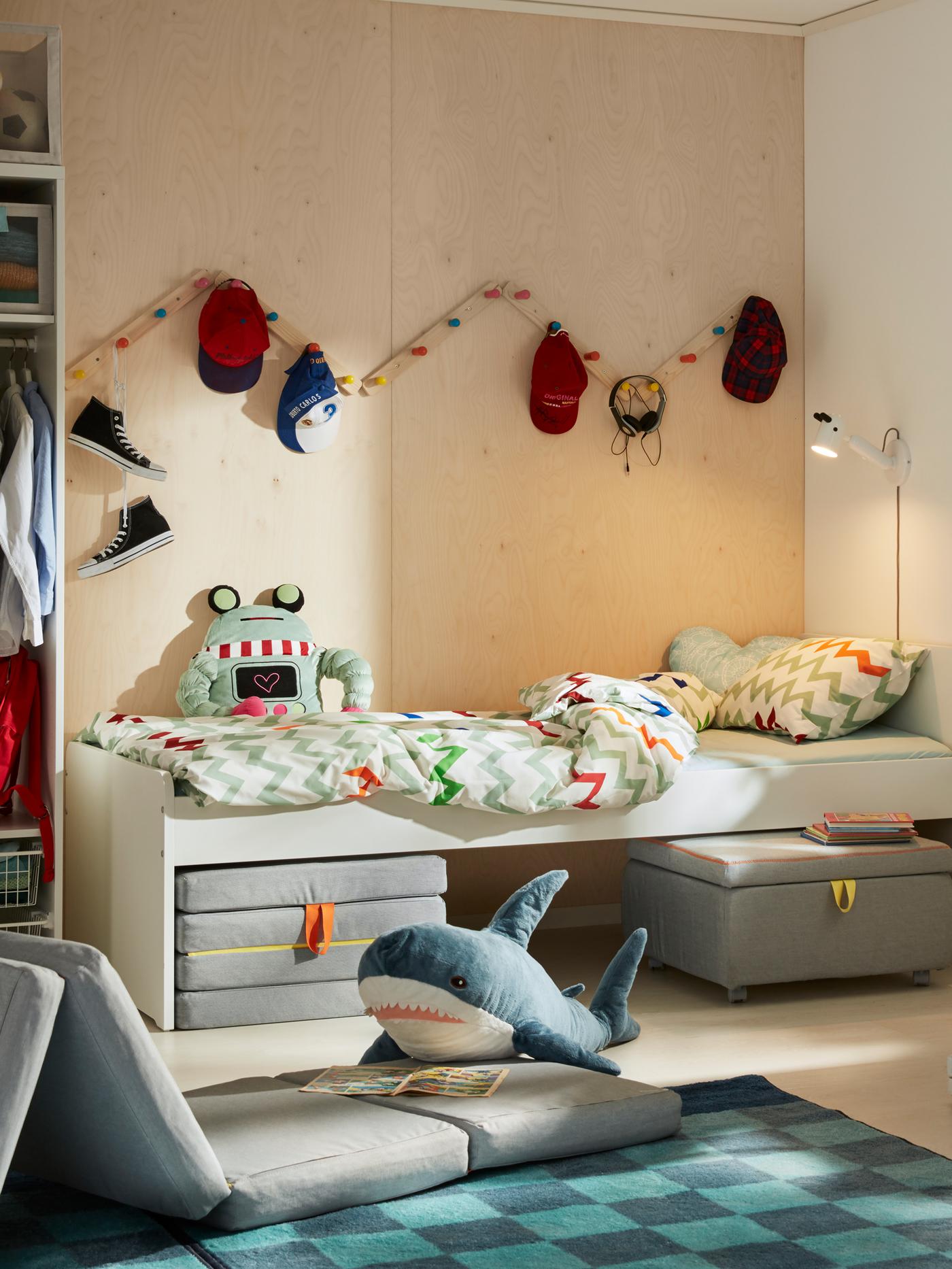 SLÄKT series with foldable playing mats under a bed