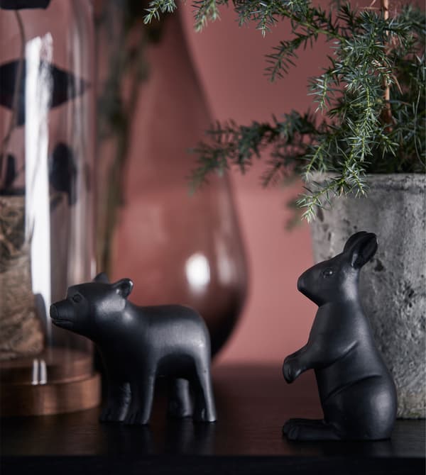 Small decorative animals are displayed on top of a display cabinet.