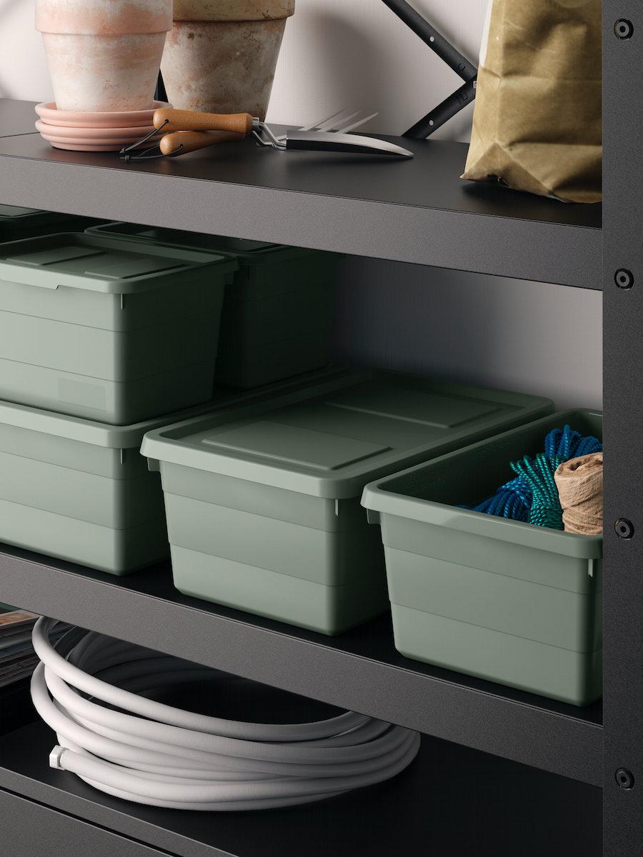 SOCKERBIT greyish-green storage boxes w lid are stacked and placed neatly in BROR shelves.