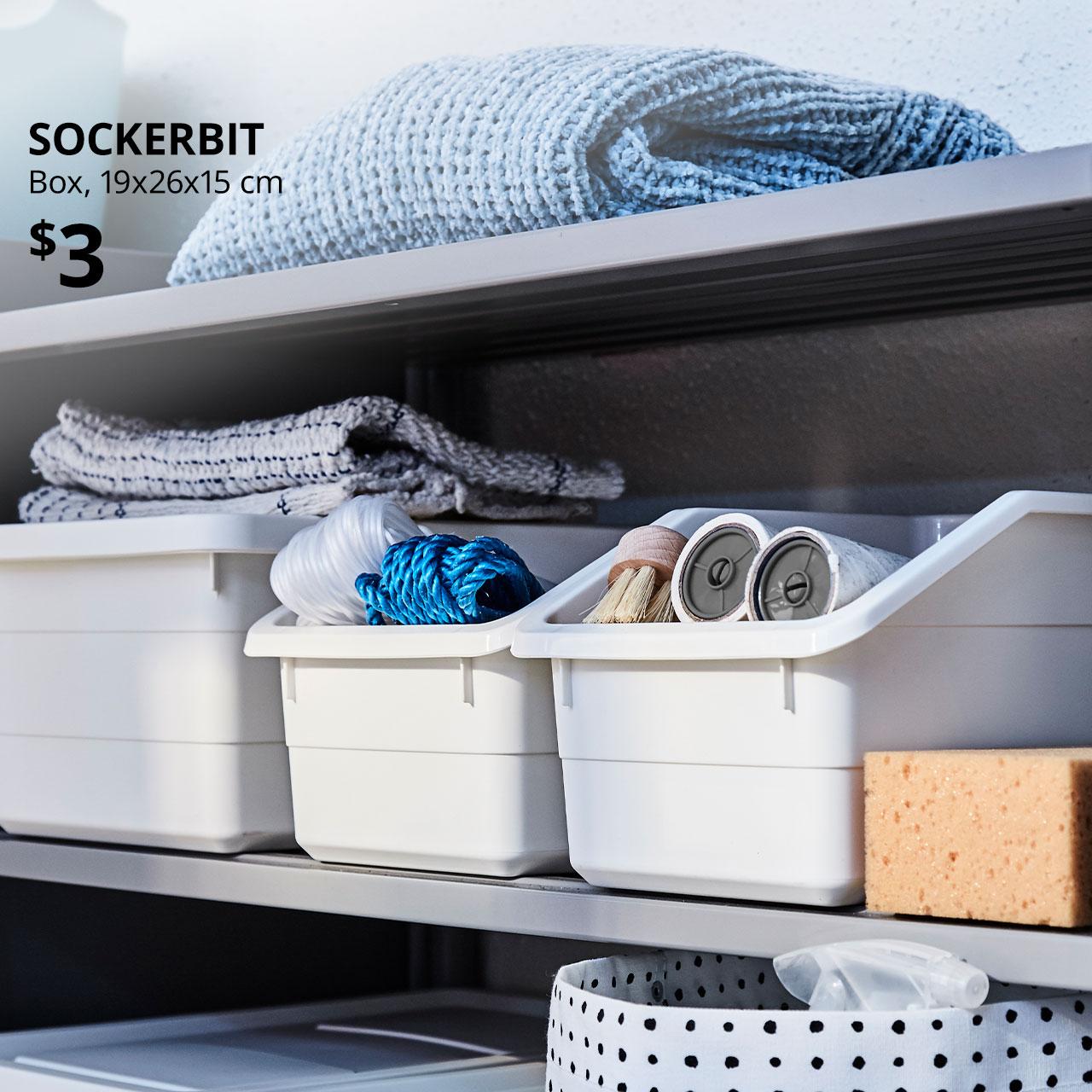 SOCKERBIT in white with home essentials like BÄSTIS lint rollers. Text on image reads &quot;SOCKERBIT, Box, 19x26x15 cm. Price at $3.&quot;